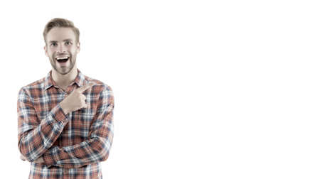 Attracting customers to buy his product. Happy guy promoting product. Man pointing finger isolated on white. Product promotion. Marketing and sales. Product advertising, copy spaceの写真素材