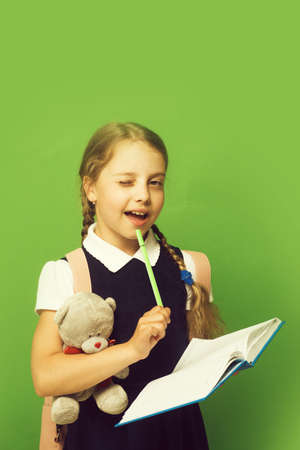 Study and back to school concept. Girl with braids winks