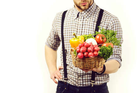 Farmer with fresh raddish, tomatoes, parsley, mushrooms and pepperの写真素材