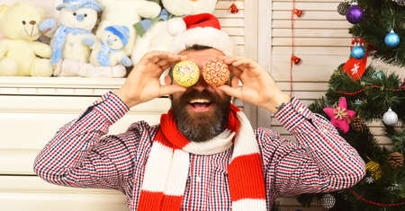 Man with beard holds golden Christmas balls.の写真素材