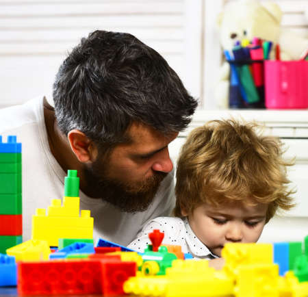 Child boy together with father playing educational toysの写真素材