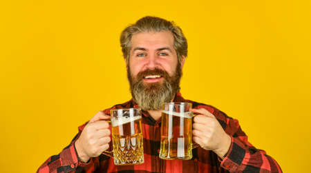st patricks day concept. having fun watching football. Brutal bearded male drinks beer from glass....