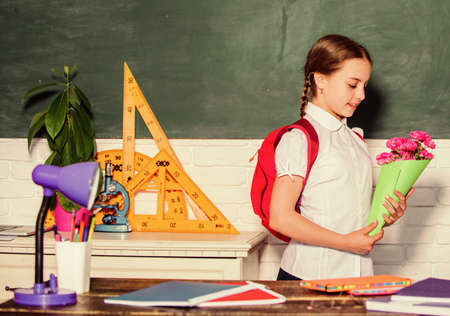 Knowledge day congratulations. September 1. Back to school. Girl adorable pupil with backpack carry...