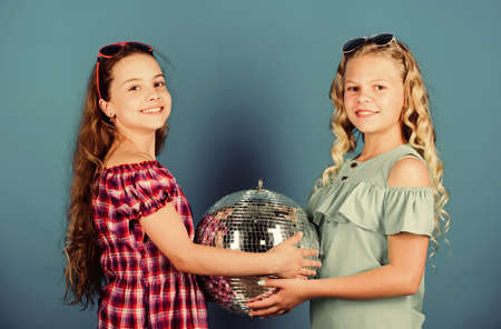 Sisters friends with disco ball. Lets start party. Cheerful kids hold disco ball. Disco dances....