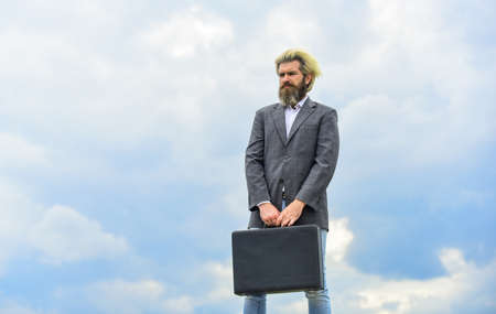 waiting for future. bearded man show office briefcase. good business deal. successful business concept. rich man with beard. live in luxury. bag with money. happy and successful man hold money caseの写真素材
