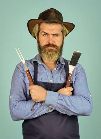 serious cowboy. Who cook better. Ultimate cooking challenge. prepare dinner for family. cooking utensils and various products. mature chef use cooking utensils for barbecue. Tools for roasting meatの写真素材