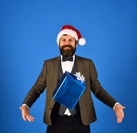 Businessman with happy face catches blue present box