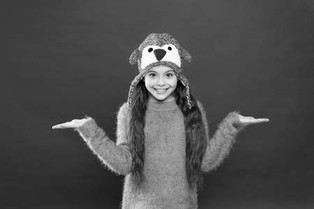 Warm and stylish trapper hat for kid. happy little girl in earflap hat. small child ready for winter. seasonal healthcare. kid fashion. Warm knitting tip. holiday activity outdoor. presenting productの写真素材