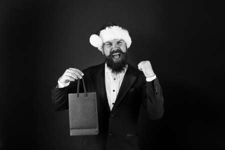 Just in time for boxing day. Happy manager hold paperbag with winner gesture. Bearded man celebrate boxing day. New year. Merry Christmas. Boxing day sale. Most wanted gift for Boxing day, copy spaceの写真素材