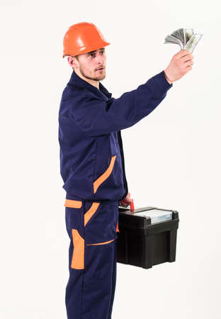 Man in helmet raising hand with money.