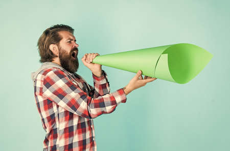 Civil rights. mass media concept. make voice louder. bearded man shout in megaphone. man with paper...
