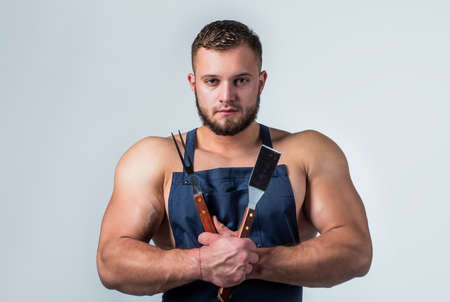Hungry. sexy man with bbq tools in cook apron. professional handsome chef cooking. culinary and...