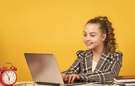 work on laptop. schoolgirl has online homework. back to school. time to study. small girl in office....