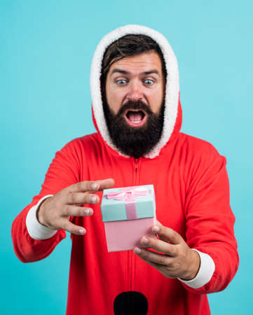 santa claus bearded man hold box wish happy new year and merry christmas holiday ready to celebrate winter party with fun and joy full of xmas presents and gifts, feeling surpriseの写真素材
