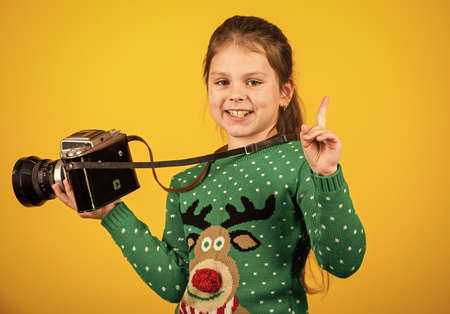 Photographer hold retro camera. Classes for kids. Learn to take photos with dslr camera. Photography courses. Education concept. Little reporter take photo. Vintage camera. Girl with retro cameraの写真素材