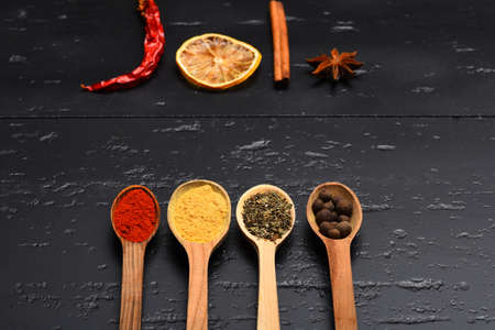 Wooden spoons with paprika, turmeric, herbs and pepperの写真素材