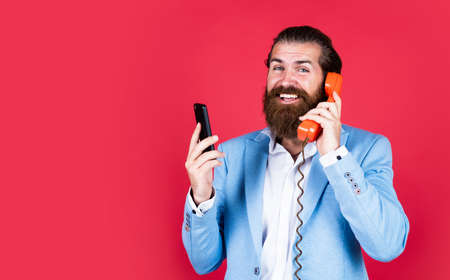 concept of technology progress. Then and Now. mature bearded man talk on retro phone. male hold...