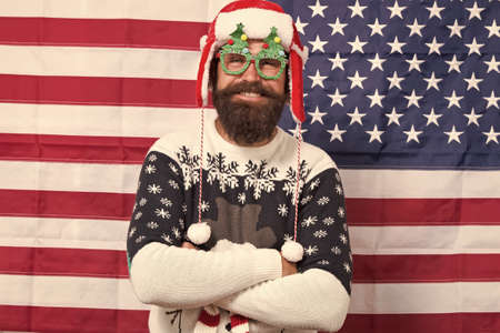 Decor and accessory. Man wear knitted sweater. American tradition. Santa Claus on american flag. Xmas and new year. Tradition of patriotism. Christmas tradition from USA. My country and traditionの写真素材