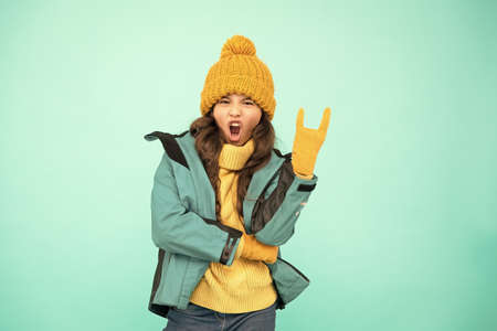 Winter collection. Child wear hat and jacket. Active leisure. Sporty style. Cute girl enjoy winter...
