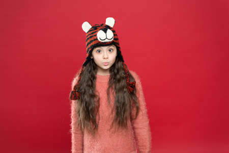 feeling surprised. christmas time activity. holiday fun. cold season accessory. serious child in...