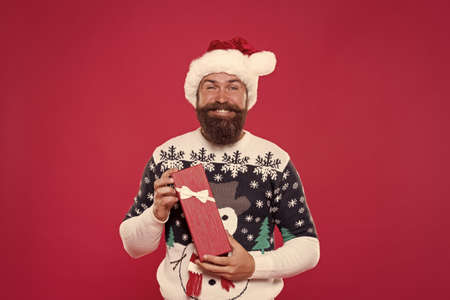Shopping before feast. Gift from santa. Happy new year. Christmas gift concept. Man celebrate holiday with gift box. Hipster winter sweater. December deal. Send present to relatives. Delivery serviceの写真素材