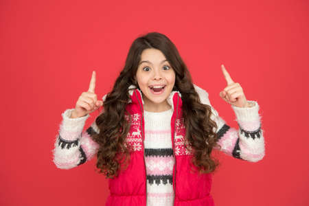 inspired child with long curly hair in christmas aparrel. cold season activity style. childhood...