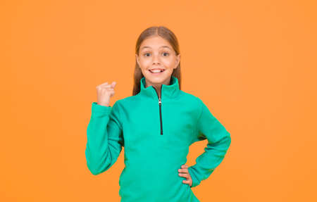 Happiness is key to success. Happy girl keep fist raised with success on yellow background. Little child enjoy success in something. Best practice and successの写真素材