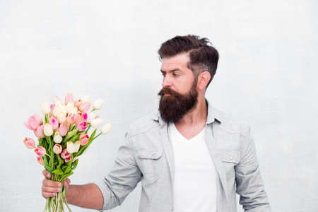 man with bouquet of tulips for her. fresh spring flowers. Concept of greeting mothers and fathers...