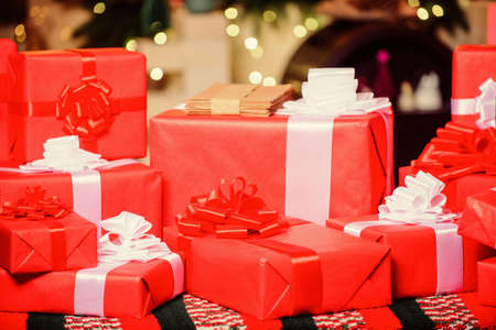 Red packages. Gift boxes with ribbon bow close up. Wrapped gifts or presents. Wrapping gifts...