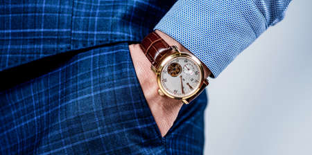 Luxury male wrist watch worn on arm in trousers pocket, timeの写真素材