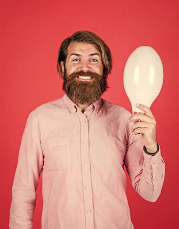 smiling man hold big lamp. got new idea. concept of creativity. man just inspired. economy of electricity. bright minded hipster. creative inspiration. light your way. bearded man with bulbの写真素材