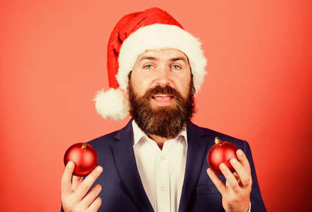 Spread magic christmas atmosphere. Radiate christmas generosity. Get into the spirit of the season. Man with beard hold red balls christmas decorations. Winter holidays. Share christmas moodの写真素材