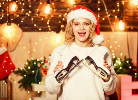 Winter sports. Ideas for winter leisure. Have fun. Snowfall and frost. Woman Santa hat hold figure...