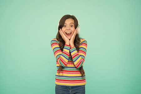 Listening album favorite artist. Happy small girl listen music. Little child enjoy song playing in headphones. Music for dancing. Party inside her head. Modern music services. Application for funの写真素材