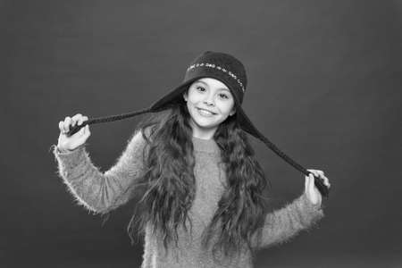 small child ready for winter. kid fashion. Warm knitting tips. happy girl in earflap hat. holiday...