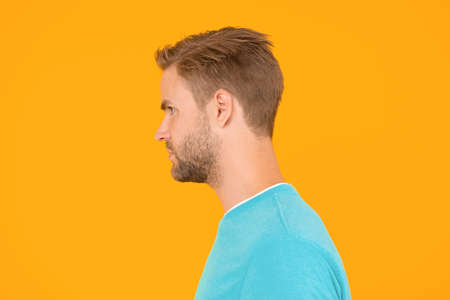 portrait of perfection. Male barber care. mens beauty. Hair and beard care. charismatic macho man profile look. guy sexy and stylish bristle. handsome man unshaven face. sexy guy yellow backgroundの写真素材