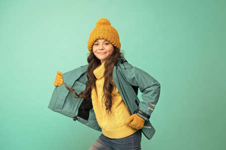 Sporty style. Carefree childhood. Cute girl enjoy winter season. Little kid wear knitted hat. Winter...