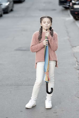Carefree weekend walk. Ready for any weather. Girl child long hair ready meet fall weather with...