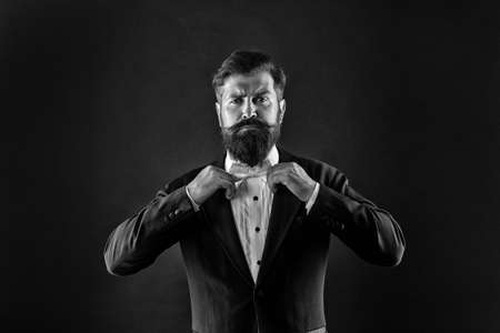 Bearded man with bow tie. Well dressed and scrupulously neat. Hipster formal suit tuxedo. Difference between vintage and classic. Official event dress code. Classic style. Menswear classic outfitの写真素材