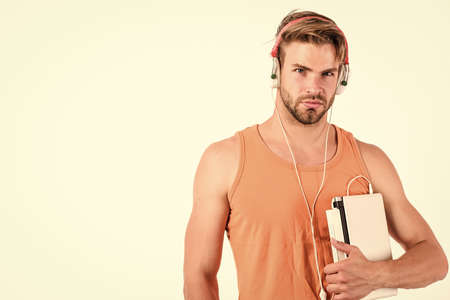 Man use modern technologies gadget. Guy with headphones and laptop. Student life. Online entertainment. Education opportunities. Gadget making life much easier. Leisure and fun. Portable gadgetの写真素材