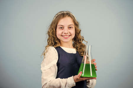 School laboratory. Learn patterns of nature. Education concept. School chemistry lesson. Chemical analysis. Harmful and vital options of chemical solute. Girl school pupil study chemical liquidsの写真素材