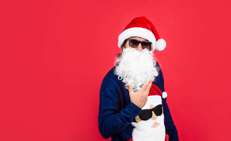 present and gift shopping sale. happy new year. merry christmas. cheerful bearded man in santa claus...