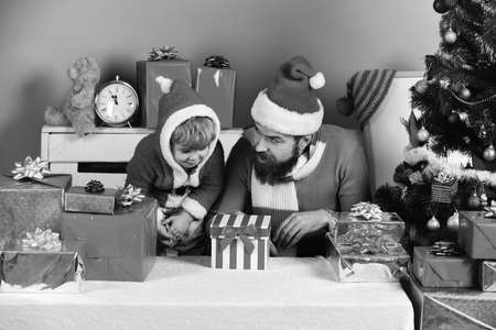 Man with beard and son with shocked faces near boxの写真素材