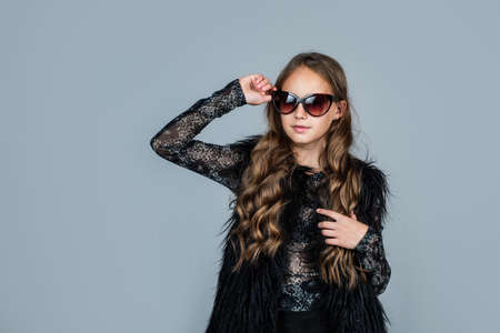 teen girl with long curly hair wear trendy sunglasses, fashion