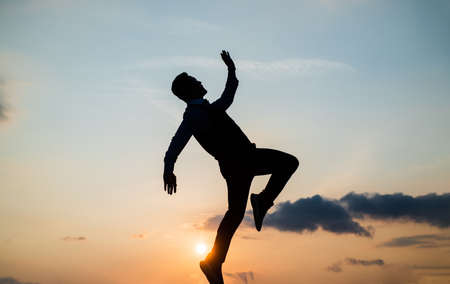 to be free. free man dancing. happiness. need the inspiration. man feel motivation. full of energy. dancer silhouette on sky background. confidence and success. concept of futureの写真素材