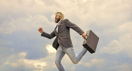 Carefree thief. Business man formal suit carries briefcase. Illegal deal business. Feel impact. Steal something. Hipster hold briefcase with bribe. Businessman run away business case. Happy workerの写真素材