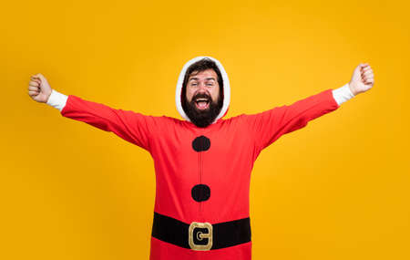 bearded santa man in hat smiling while prepare for celebrating happy new year party and christmas holiday in winter going to have xmas presents, joyの写真素材