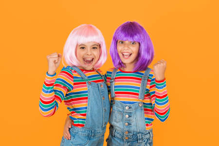 Anime fan. Animation style characterized colorful graphics vibrant characters fantastical themes. Anime convention. Happy little girls. Cheerful friends in colorful wigs. Anime cosplay party conceptの写真素材
