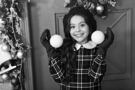 home at Christmas. winter holiday activity. season shopping. small french girl. stylish kid decorative xmas ball. decorate home and christmas tree. happy new year. cheerful girl in beret and glovesの写真素材