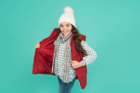 kid fashion and shopping. xmas time. ready for new year vacation. no hypothermia. cheerful girl wearing layers of clothing. warm clothes at wintertime season. cold weather forecast. Be happyの写真素材